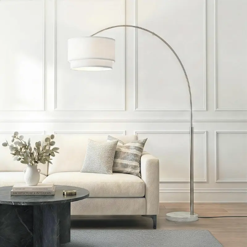 Mid-range brass tripod floor lamp adding designer silhouette to living room