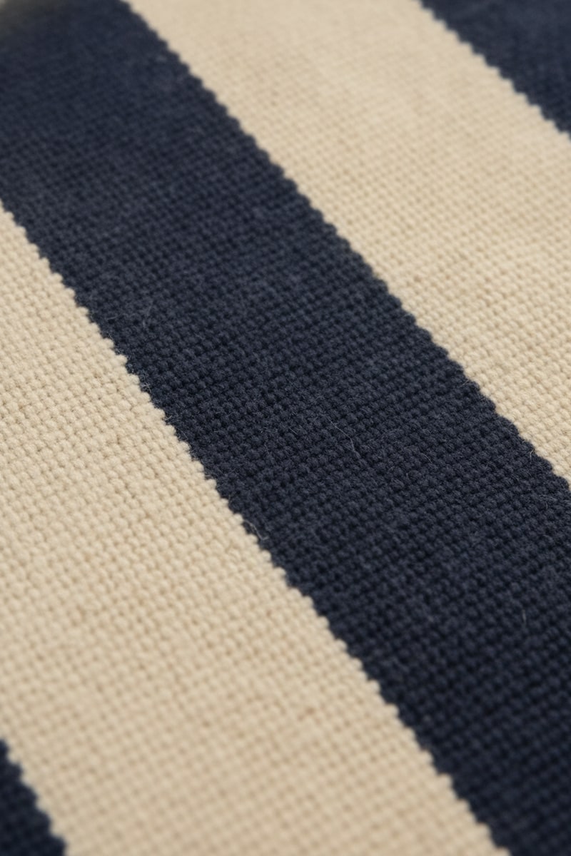 Navy and Cream Coastal Stripe Cotton Rug styled in a room