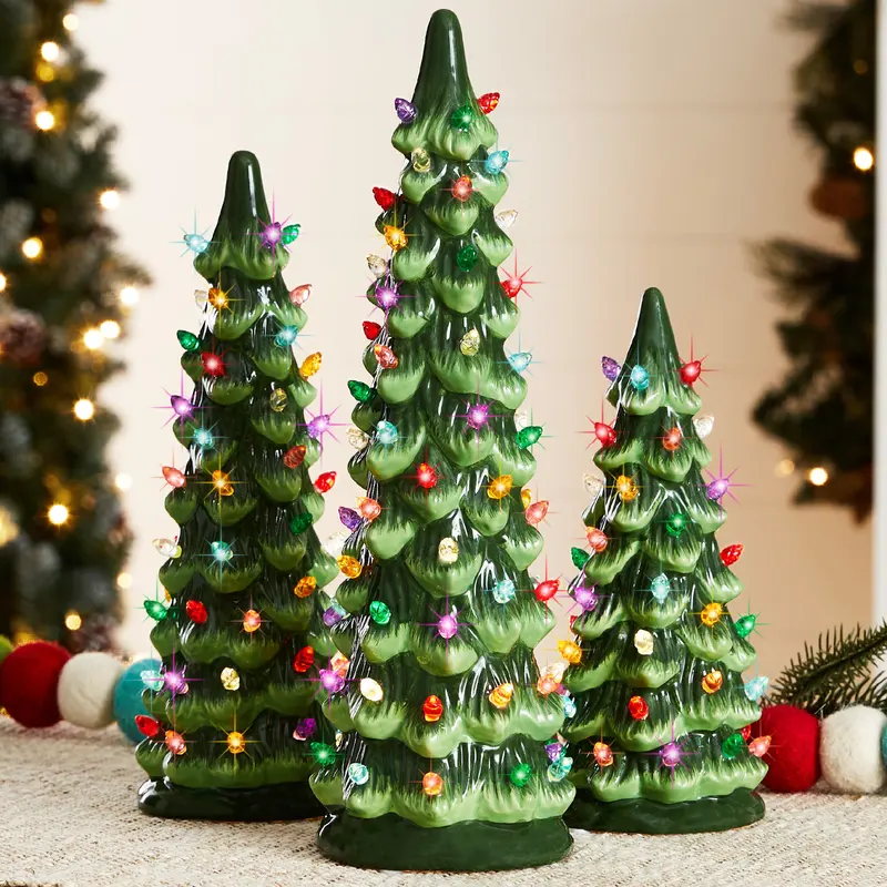 Set of 3 Pre-Lit Ceramic Christmas Trees styled in a room