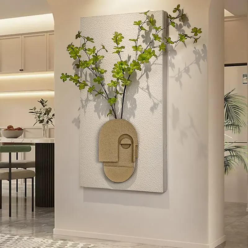 Sandstone Abstract Sculpture Wall Decor with Greenery styled in a room